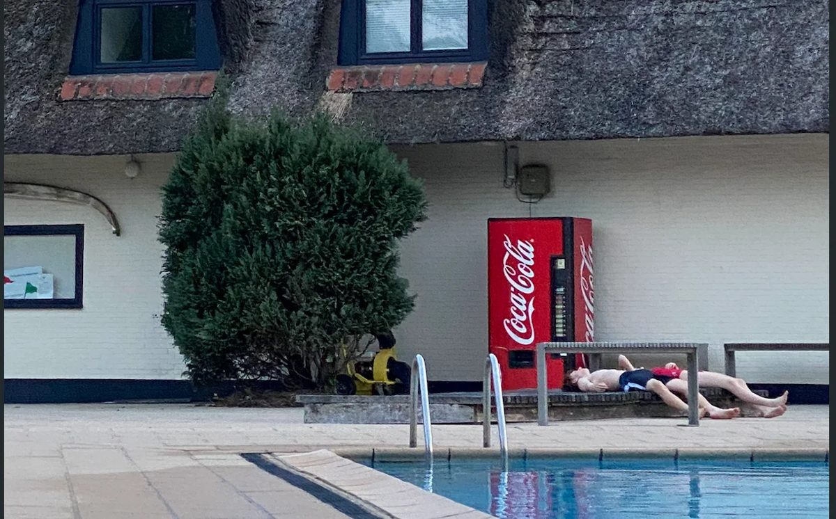 Sunbathing by a hotel pool on holiday