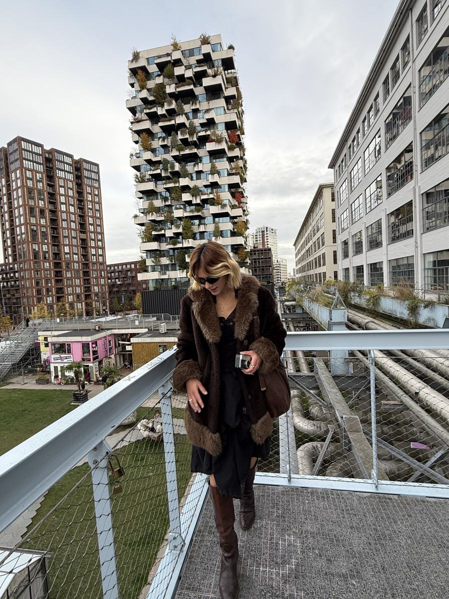 Katya on the walkway above Strijp-S, with the plant-covered Trudo tower behind her