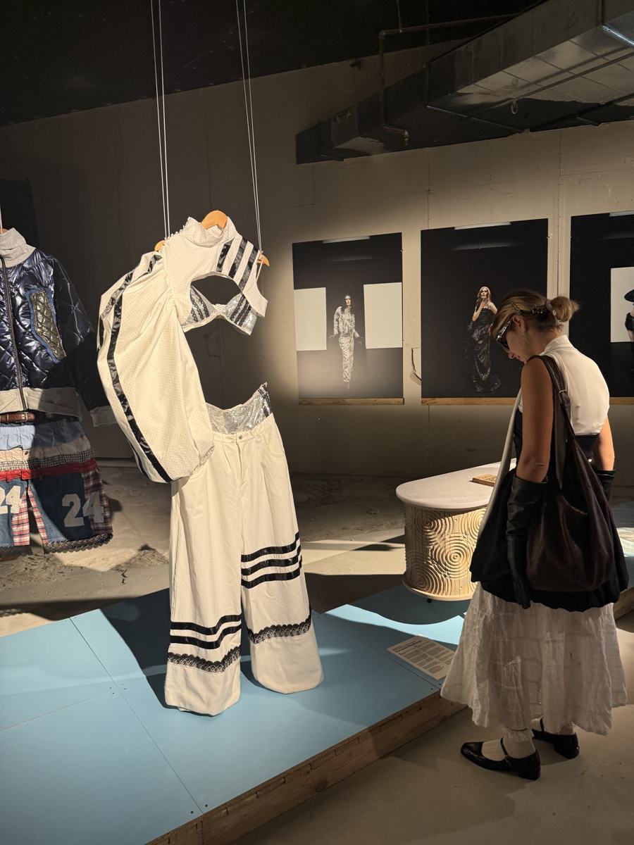 Katya looking at a sculptural white garment in a Dutch Design Week exhibition